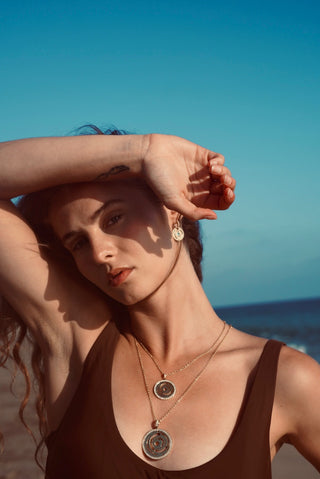 Rising Sun Drops in 18k gold with blue topaz