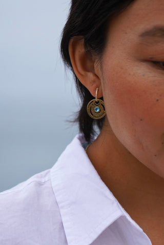 Rising Sun Drops in 18k gold with blue topaz